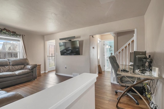 1112 Marquette Ave, Green Bay, WI 54304 - living room with baseboards, stairs, wood finished floors, and visible vents