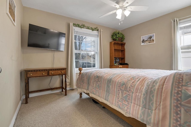 1112 Marquette Ave, Green Bay, WI 54304 - carpeted bedroom featuring a ceiling fan, baseboards, and multiple windows