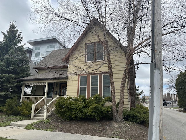 view of front of property featuring a porch and a shingled roof