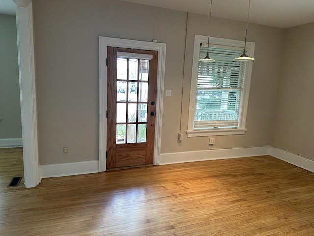 entryway featuring light wood-style floors, baseboards, and visible vents