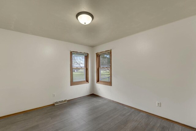 8022 W Glenbrook Rd, Milwaukee, WI 53223 - unfurnished room featuring baseboards, visible vents, and wood finished floors