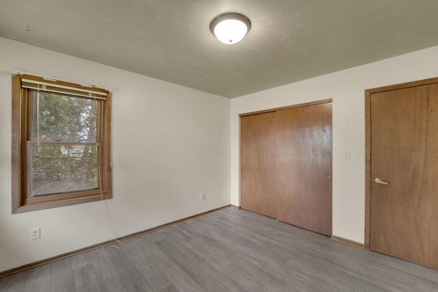 8022 W Glenbrook Rd, Milwaukee, WI 53223 - unfurnished bedroom featuring baseboards and wood finished floors