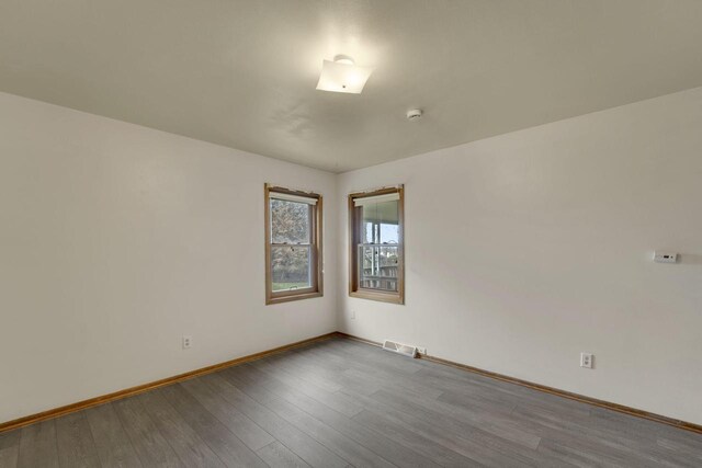 8022 W Glenbrook Rd, Milwaukee, WI 53223 - unfurnished room with visible vents, baseboards, and wood finished floors