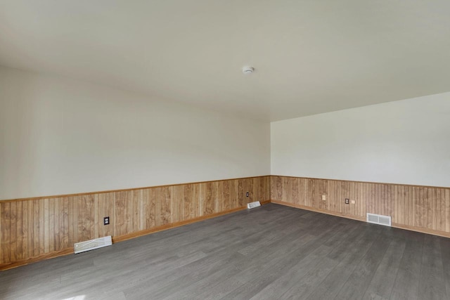 8022 W Glenbrook Rd, Milwaukee, WI 53223 - empty room featuring dark wood-style flooring, visible vents, and wainscoting