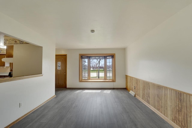 8022 W Glenbrook Rd, Milwaukee, WI 53223 - unfurnished living room featuring visible vents, baseboards, and wood finished floors
