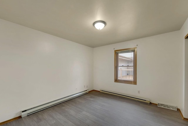 8022 W Glenbrook Rd, Milwaukee, WI 53223 - empty room with visible vents, wood finished floors, and a baseboard radiator