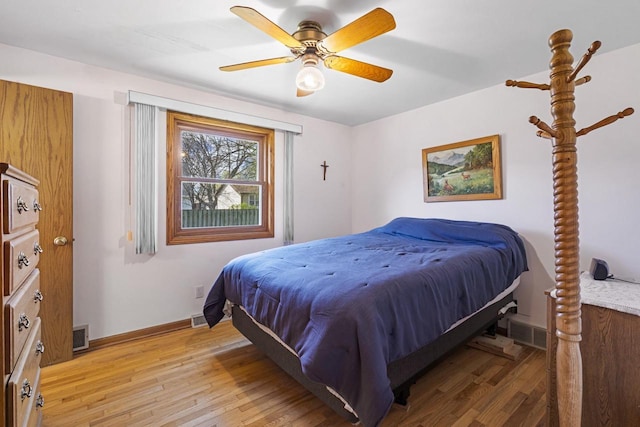 bedroom featuring a ceiling fan, baseboards, visible vents, and light wood finished floors