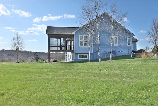 203 Walnut Hill Way, River Falls, WI 54022 - back of property with a lawn and a sunroom