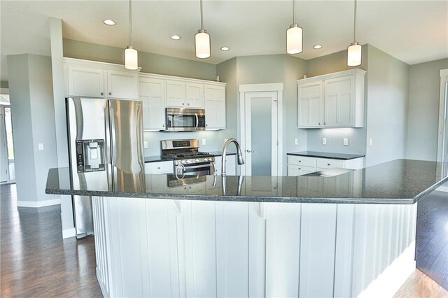 203 Walnut Hill Way, River Falls, WI 54022 - kitchen with appliances with stainless steel finishes, recessed lighting, dark wood finished floors, baseboards, and white cabinetry
