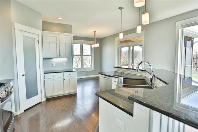 203 Walnut Hill Way, River Falls, WI 54022 - kitchen featuring a sink, stainless steel appliances, dark wood-style floors, white cabinets, and hanging light fixtures