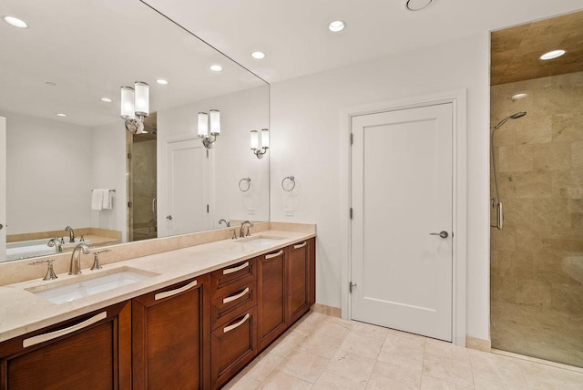 full bathroom with recessed lighting, a sink, and a shower stall
