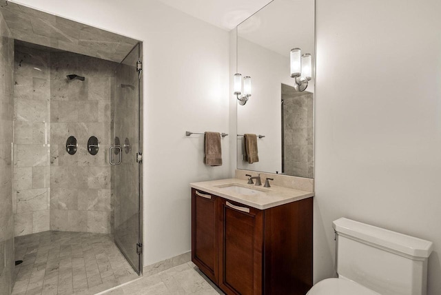 bathroom featuring vanity, toilet, baseboards, and a stall shower