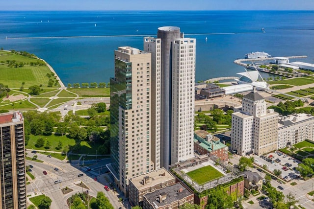 birds eye view of property featuring a view of city and a water view