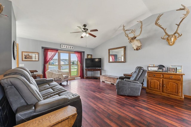 living area featuring ceiling fan, wood finished floors, and vaulted ceiling