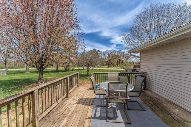 wooden deck featuring a yard