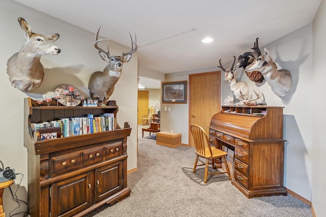 carpeted home office featuring baseboards