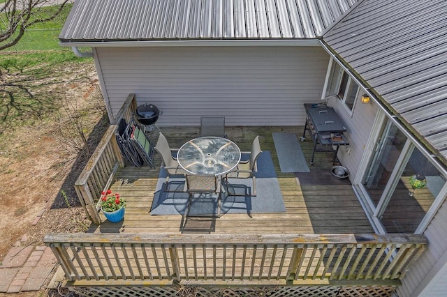 wooden terrace with outdoor dining area