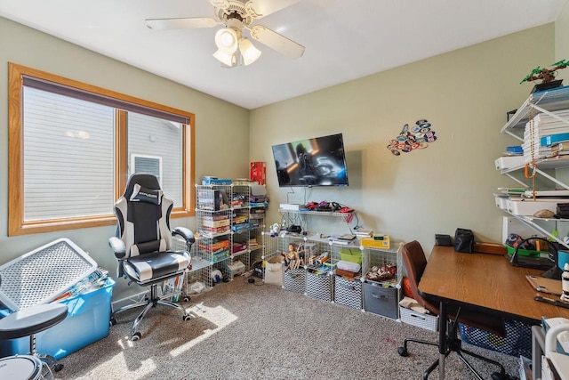 carpeted office featuring a ceiling fan