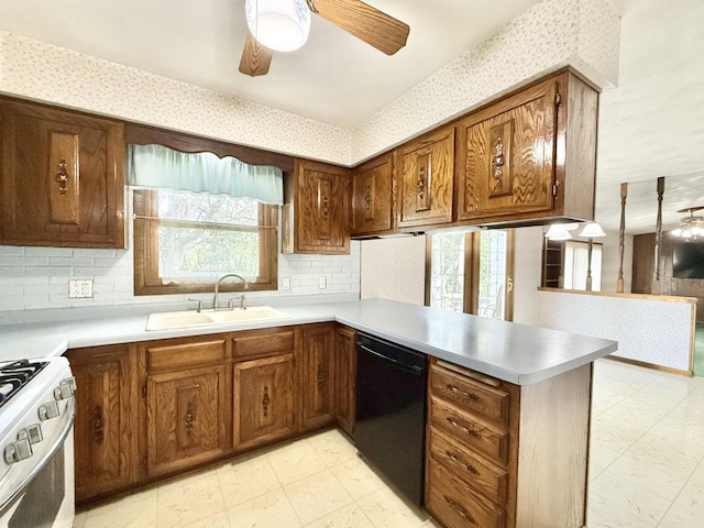 226 Westridge Rd, Janesville, WI 53548 - kitchen with white gas stove, a ceiling fan, a sink, a peninsula, and black dishwasher