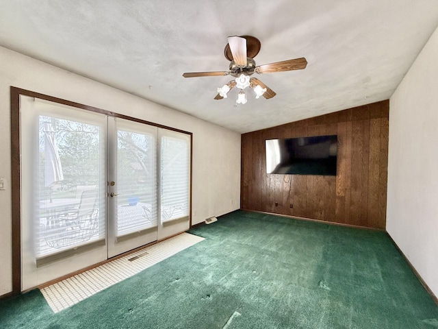 226 Westridge Rd, Janesville, WI 53548 - carpeted empty room featuring a ceiling fan and wood walls