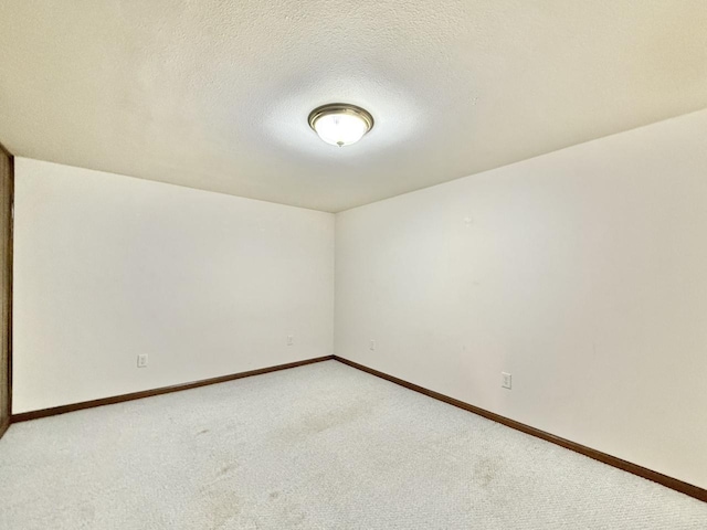 226 Westridge Rd, Janesville, WI 53548 - unfurnished room featuring light colored carpet, a textured ceiling, and baseboards