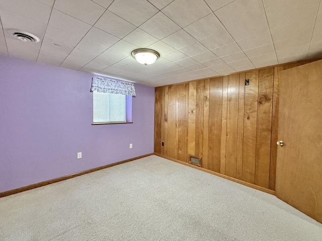 226 Westridge Rd, Janesville, WI 53548 - below grade area featuring visible vents, carpet, baseboards, and wooden walls