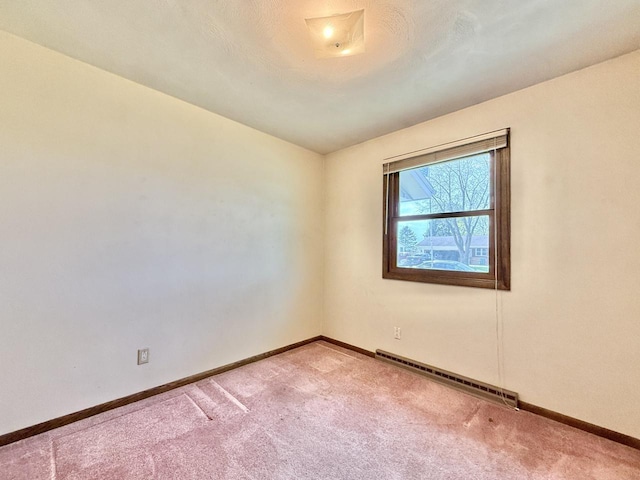 226 Westridge Rd, Janesville, WI 53548 - empty room featuring baseboards, carpet, and a baseboard heating unit