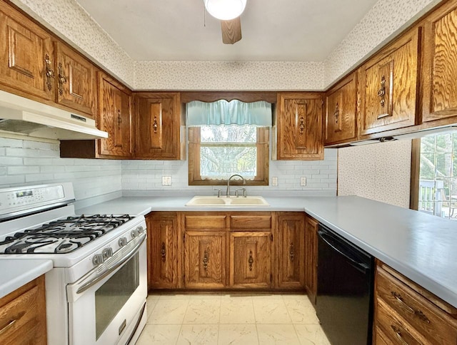 226 Westridge Rd, Janesville, WI 53548 - kitchen featuring white gas stove, wallpapered walls, under cabinet range hood, a sink, and dishwasher
