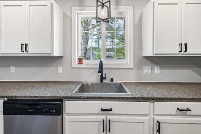kitchen with a sink, white cabinetry, dishwasher, and dark countertops