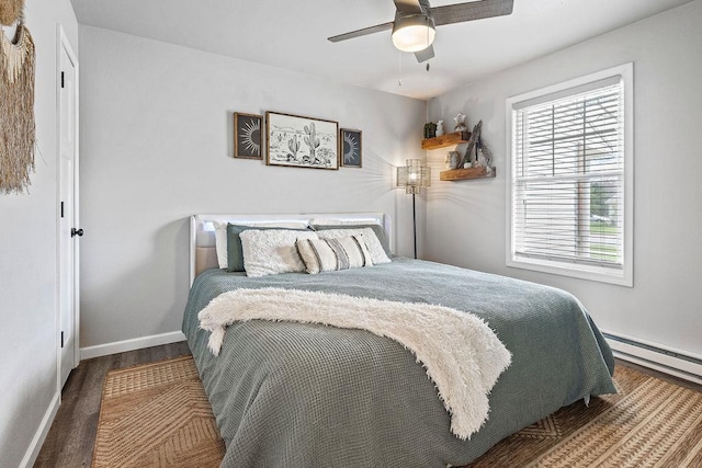 bedroom with baseboards, a ceiling fan, a baseboard radiator, and wood finished floors
