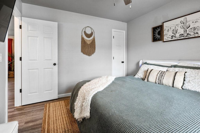 bedroom with baseboards and wood finished floors