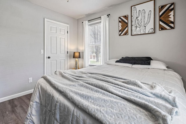 bedroom featuring baseboards and wood finished floors