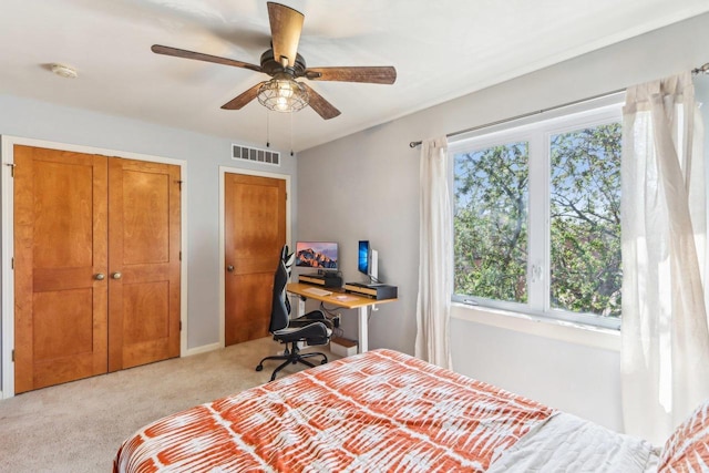 bedroom featuring carpet floors, ceiling fan, visible vents, and baseboards