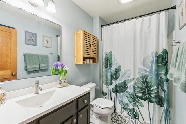 bathroom featuring toilet, curtained shower, and vanity