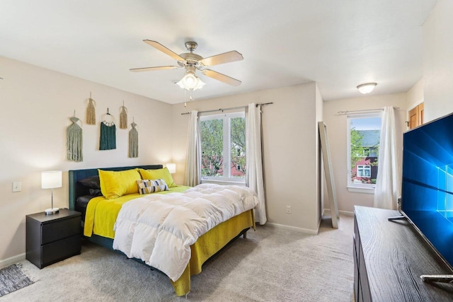bedroom with baseboards, ceiling fan, and light carpet