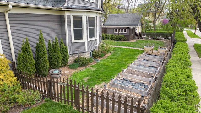 view of yard featuring fence, a vegetable garden, and stairway