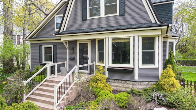 view of front of home with a shingled roof and a gambrel roof