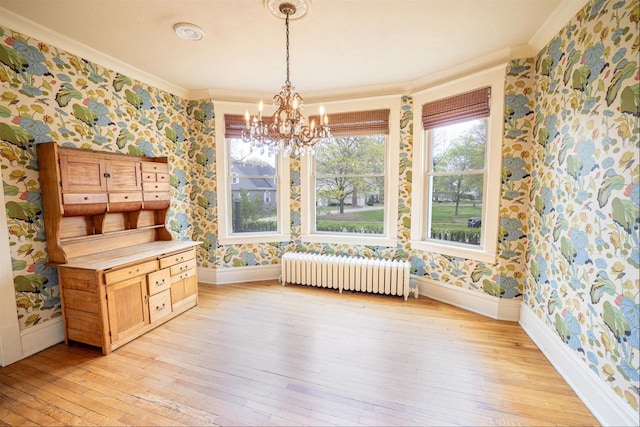 dining area with radiator, baseboards, ornamental molding, and wallpapered walls