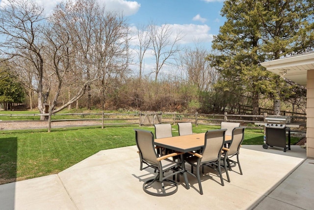 view of patio featuring a fenced backyard, outdoor dining area, and a grill