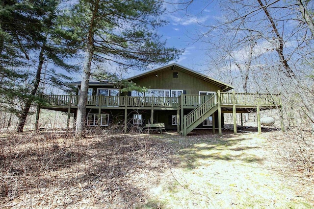 view of front of home featuring stairway and a deck