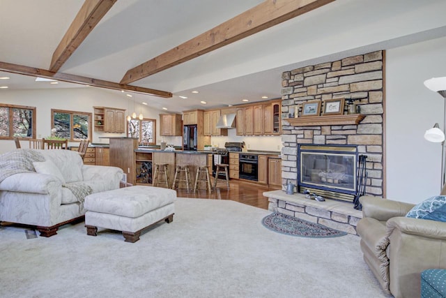 living room featuring recessed lighting, a fireplace, and beamed ceiling