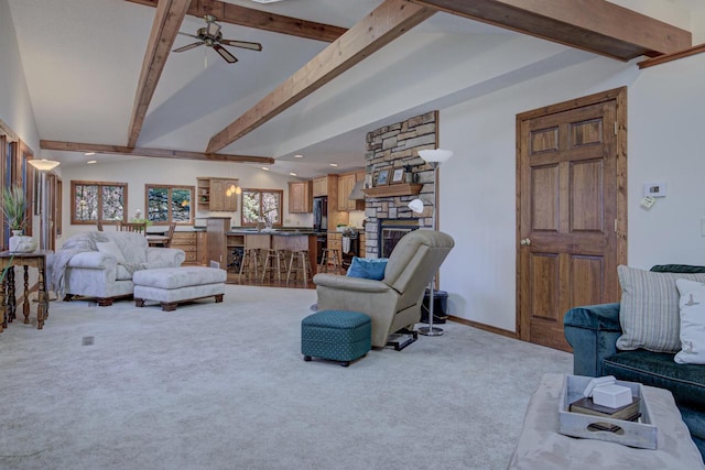 living area featuring ceiling fan, a stone fireplace, vaulted ceiling with beams, carpet flooring, and recessed lighting