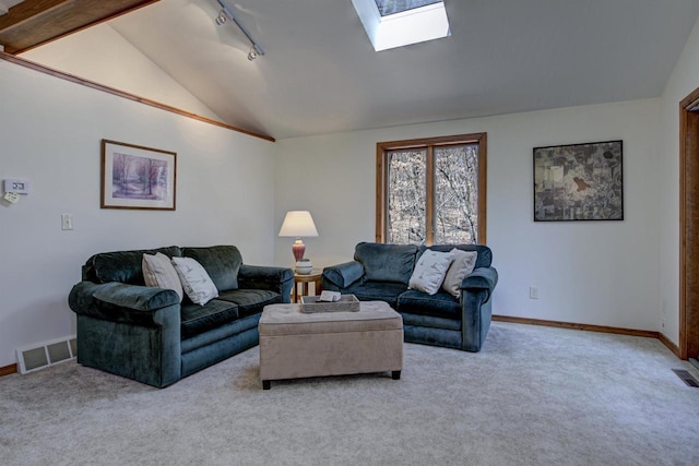 living area with visible vents, baseboards, vaulted ceiling with skylight, and light carpet
