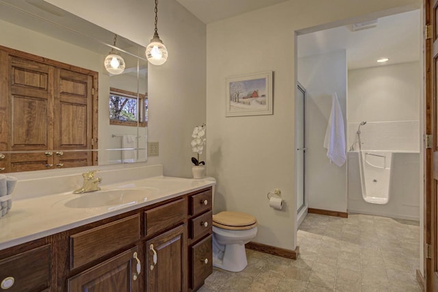 bathroom with vanity, baseboards, a shower stall, and toilet