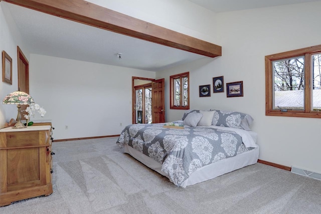 bedroom with beamed ceiling, baseboards, visible vents, and light carpet