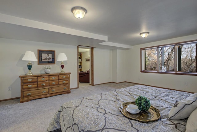 bedroom featuring baseboards and light carpet