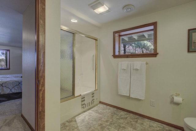 ensuite bathroom featuring connected bathroom, shower / bath combination with glass door, toilet, baseboards, and visible vents