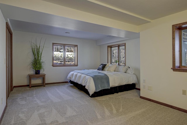 bedroom with baseboards and carpet