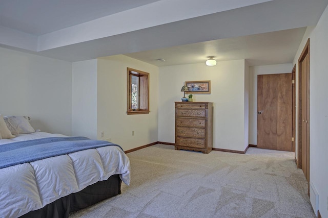 bedroom featuring baseboards and light colored carpet