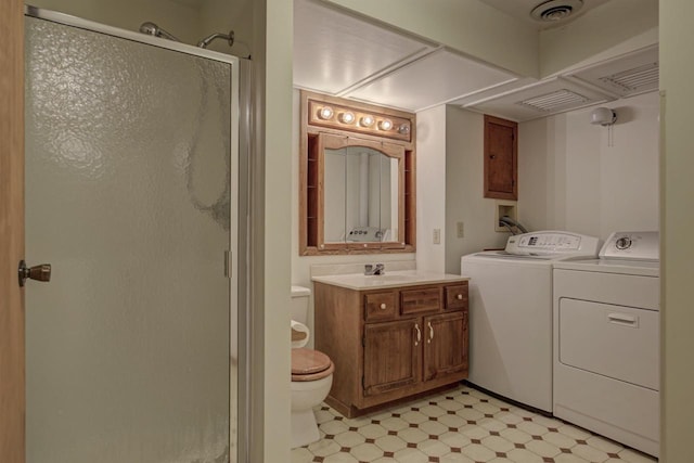 bathroom featuring toilet, tile patterned floors, a shower stall, visible vents, and washer and clothes dryer